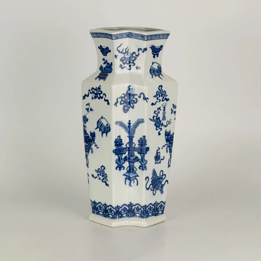 Blue and white ceramic vase with floral pattern design perfect for elegant table or shelf decor placement in modern home interior.