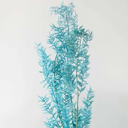 Closeup of turquoise preserved foliage stem with natural style leaves perfect for DIY vase decoration and home interior design.