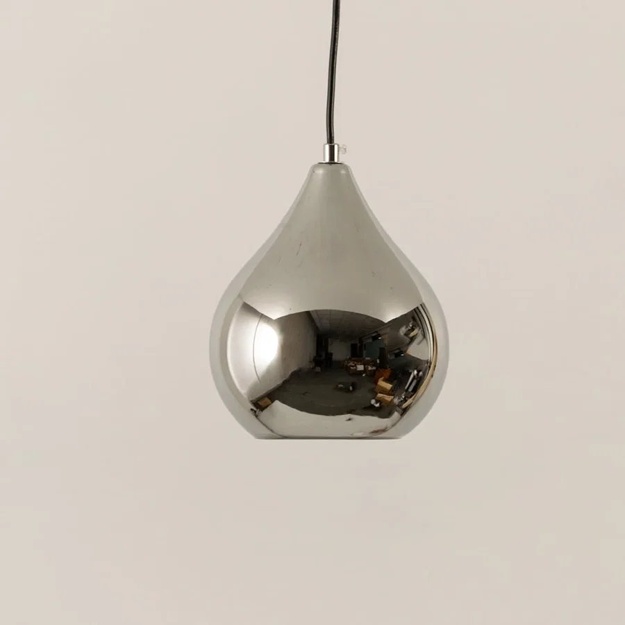 Silver metal pendant light illuminated to showcase reflective modern ceiling lighting with luxury decorative elegance.