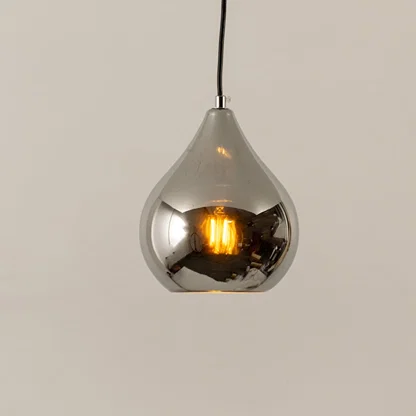 Silver metal pendant light illuminated to highlight sleek modern ceiling lighting with reflective decorative elegance.