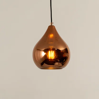 Copper finish metal pendant light with glossy surface and warm glow ideal for modern kitchen or dining decor placement.