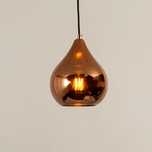 Copper finish metal pendant light with glossy surface and warm glow ideal for modern kitchen or dining decor placement.