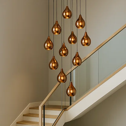 Copper metal pendant lights cascading above staircase creating dramatic ambient lighting in a luxury interior setting.