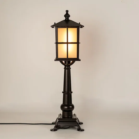 Black outdoor gate light with warm glowing panels for luxury exterior decor styling use.
