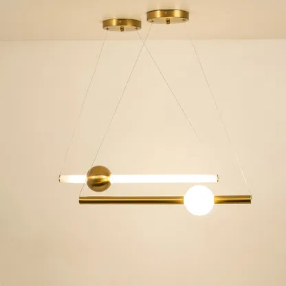 Gold metal linear pendant light illuminated with frosted globe shade showcasing modern ceiling lighting elegance.