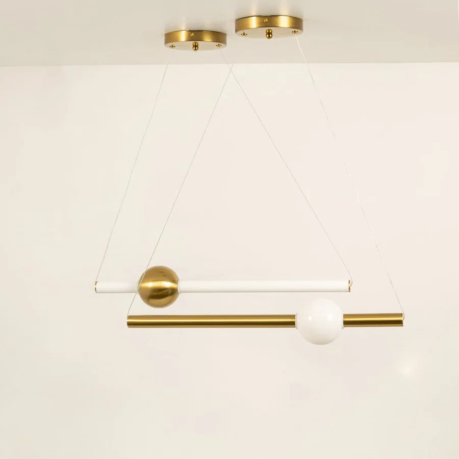 Gold metal linear pendant light displaying sleek suspended design and contemporary decorative ceiling lighting style.
