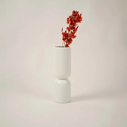 Minimal white ceramic vase displayed on a clean white background offering a modern sculptural decor look.
