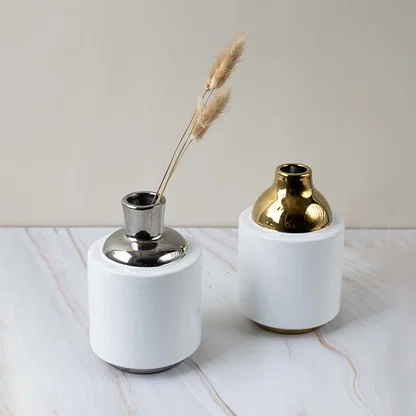 Grouped set of modern ceramic vases with metallic silver and gold accents perfect for home decor styling.