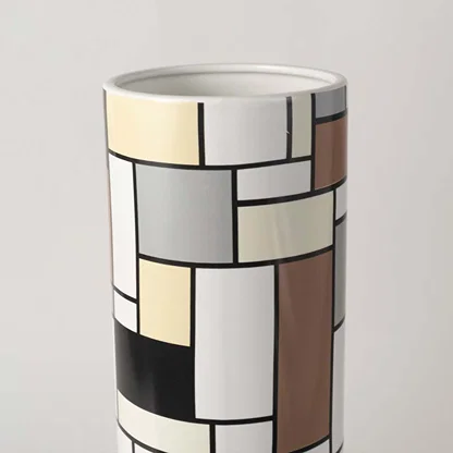 Closeup view of the white ceramic sculptural vase showing its smooth flowing curves and artistic handcrafted modern design.