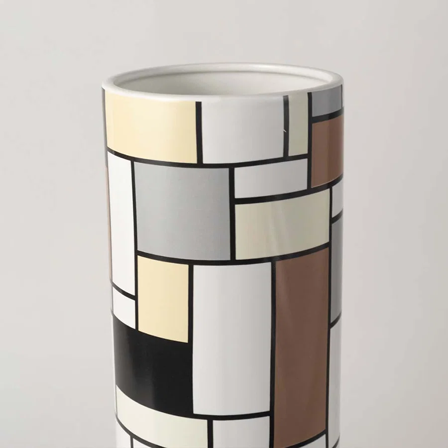 Closeup view of the white ceramic sculptural vase showing its smooth flowing curves and artistic handcrafted modern design.