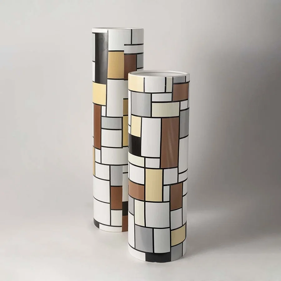 Artistic white sculptural ceramic vase displayed as part of a curated decor setup adding contemporary elegance to interiors.