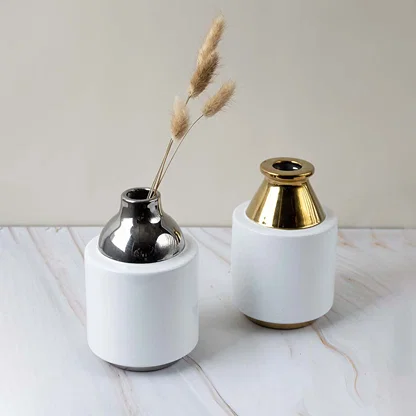 Collection of ceramic vases with glossy white body and metallic silver neck designed for stylish home interior display.