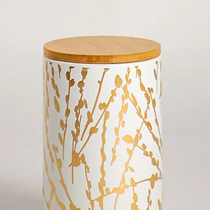 Closeup view of a ceramic jar with a golden botanical design and smooth wooden lid  showcasing its texture  detailing  and clean finish.
