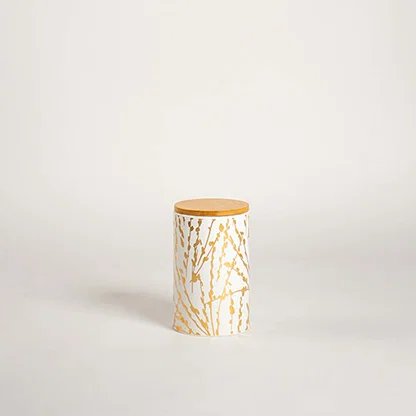 White ceramic cylinder vase with gold marble vein pattern and metallic gold top on white background for luxury decor.