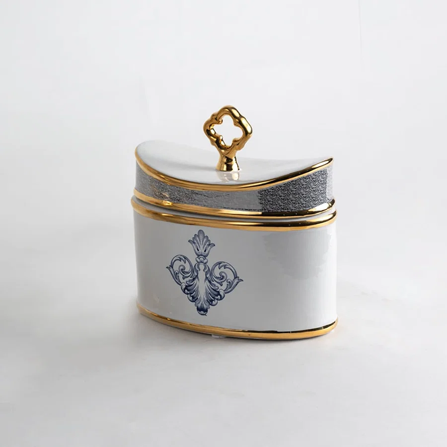 White ceramic jar with blue and gold artwork in a front view perfect for refined décor styling and elegant console placement.