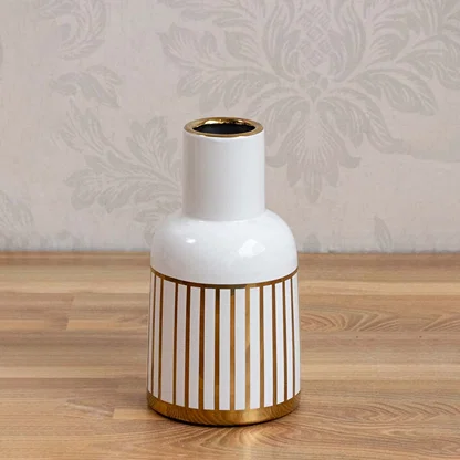 A sleek white ceramic vase accented with gold stripes photographed on a clean background highlighting its glossy finish and contemporary style.