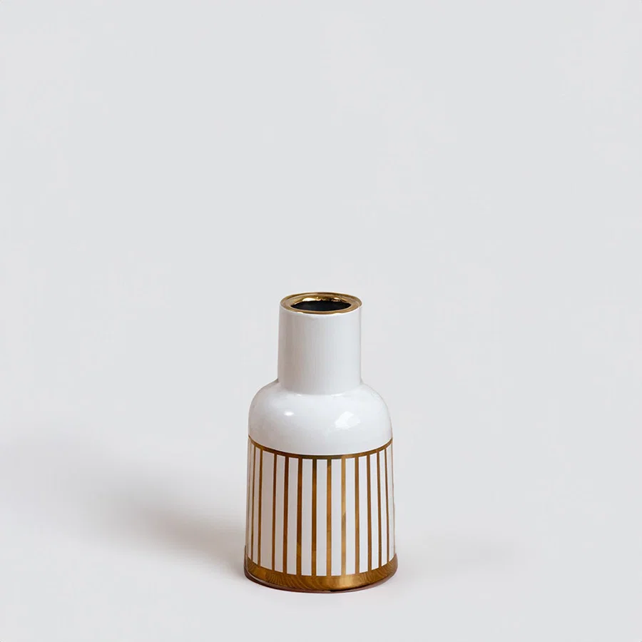 White ceramic decorative vase with gold ribbed detailing and gold rim for tabletop styling and modern home decor.