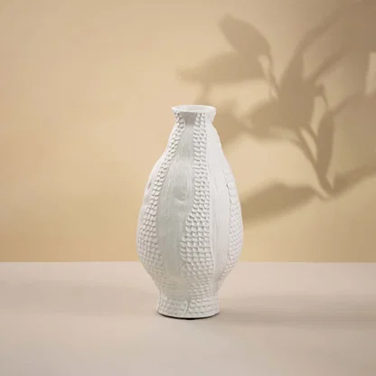 White ceramic decorative vase with woven texture and bottle silhouette for sophisticated tabletop styling and decor.
