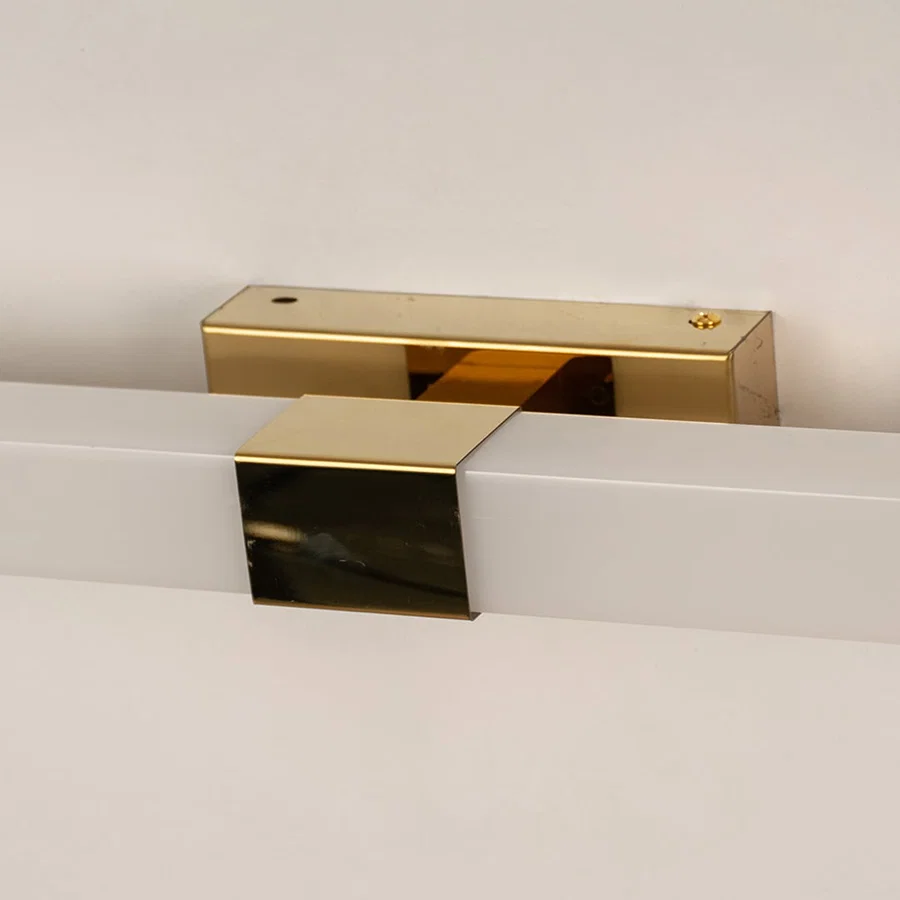 Closeup of white and gold picture light showing sleek bar design for stylish modern wall lighting and elegant home décor accents.