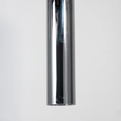 Chrome metal pendant light with reflective polished finish and sleek cylindrical form for modern luxury interior decor.