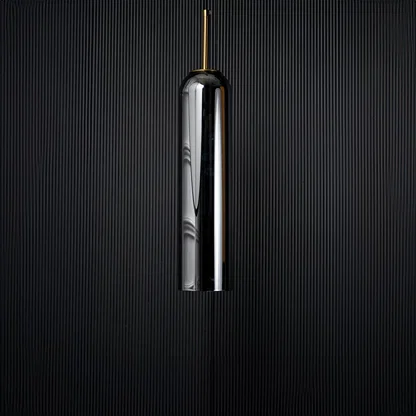 A tall silver cylindrical pendant light displayed on a black background with the light turned off emphasizing its glossy surface and slim elegant silhouette.