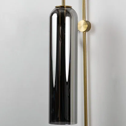 Closeup of black glass and gold metal wall light for modern bedroom and luxury decor styling spaces.

