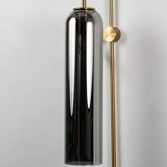 Closeup of black glass and gold metal wall light for modern bedroom and luxury decor styling spaces.

