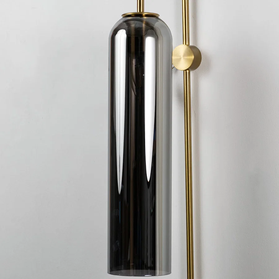 Closeup of black glass and gold metal wall light for modern bedroom and luxury decor styling spaces.

