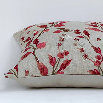 White cotton cushion cover with red botanical leaf print featuring premium cotton fabric texture and elegant stitched finish.