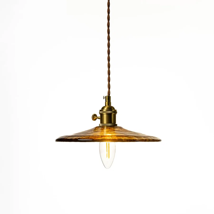 Brass metal pendant light with vintage disc shade designed for elegant dining room decor spaces.