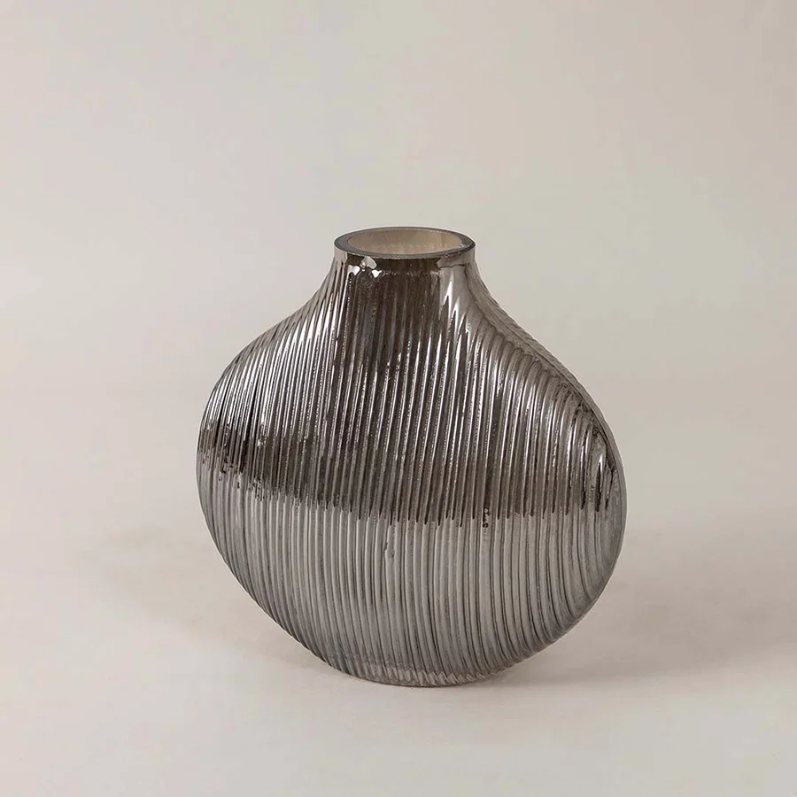 Side angle view of ribbed smoky glass vase showcasing curved profile and glossy surface for a stylish modern tabletop decor piece.