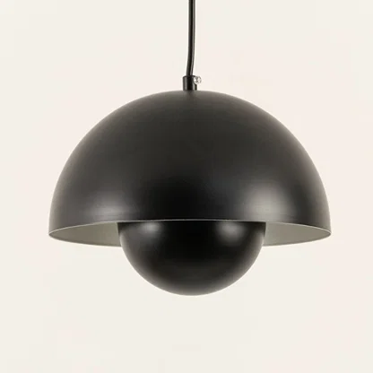 Closeup of black metal pendant light with smooth layered dome showcasing premium craftsmanship.
