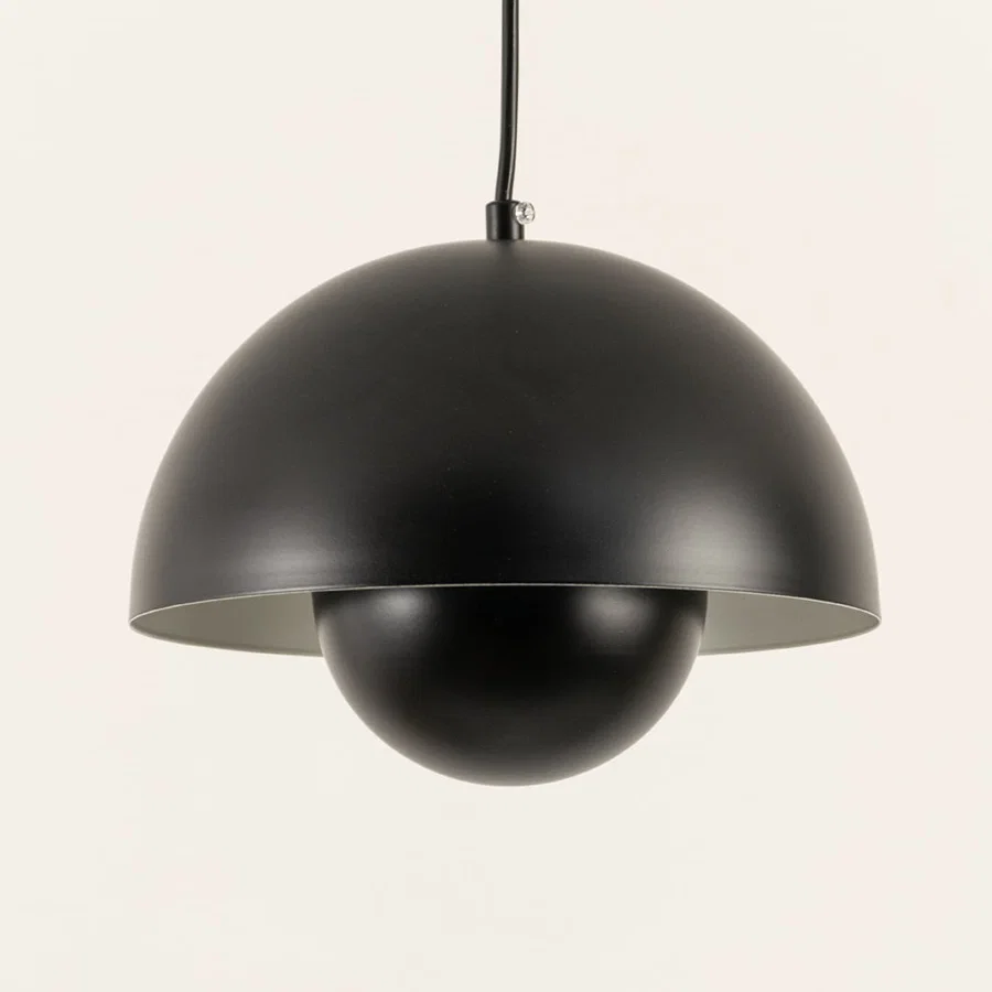 Closeup of black metal pendant light with smooth layered dome showcasing premium craftsmanship.