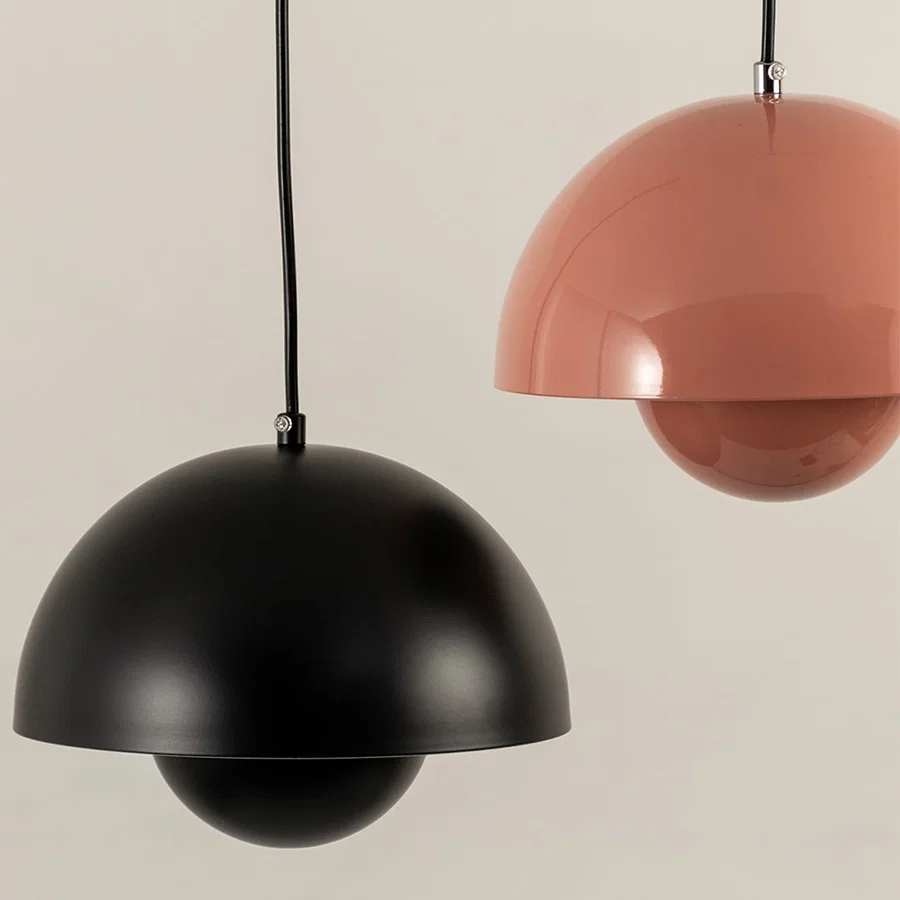 Black and peach metal pendant lights with layered design adding contemporary charm to interiors.