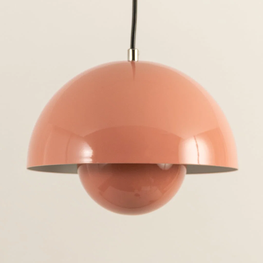 Closeup of peach metal pendant light showcasing layered dome design and premium craftsmanship.