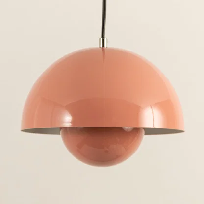 Closeup of peach metal pendant light showcasing layered dome design and premium craftsmanship.