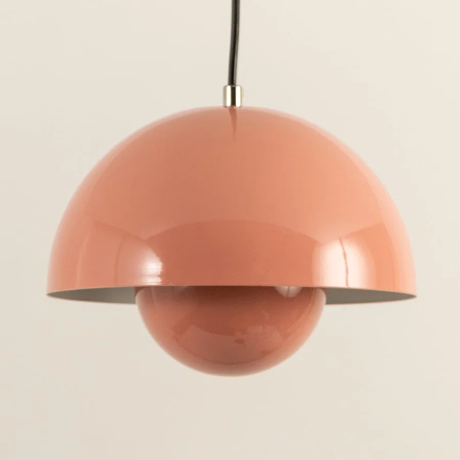 Closeup of peach metal pendant light showcasing layered dome design and premium craftsmanship.