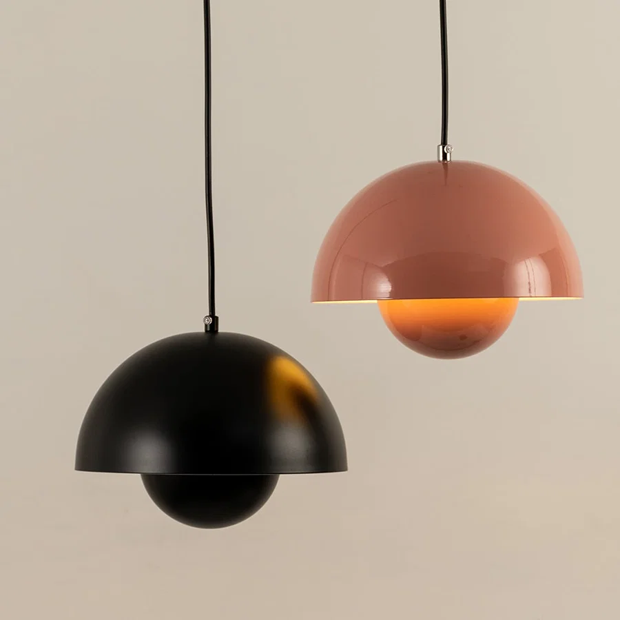 Illuminated black and peach metal pendant light creating warm ambient lighting for contemporary homes.