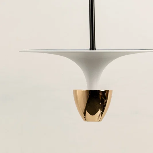 Closeup of white pendant light with gold metallic accent for luxury modern interior and dining decor styling.
