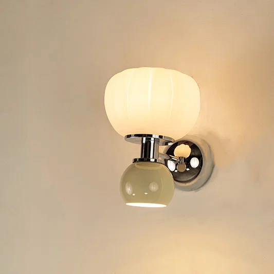 Modern white glass wall light with warm glow for elegant bedroom and luxury decor styling spaces.