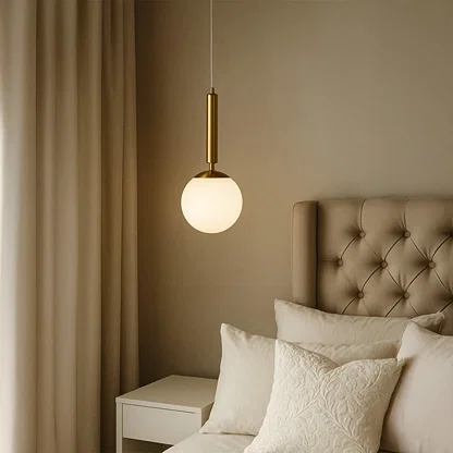 White glass pendant light beside bed adding soft ambient lighting and contemporary elegance to modern bedroom decor.