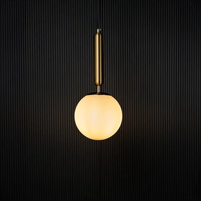 Modern pendant light glowing warmly against a dark background creating a striking contrast that highlights its elegant gold and white finish.