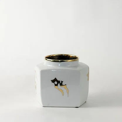 White ceramic decorative storage jar with gold bee artwork for contemporary tabletop styling and modern home decor.