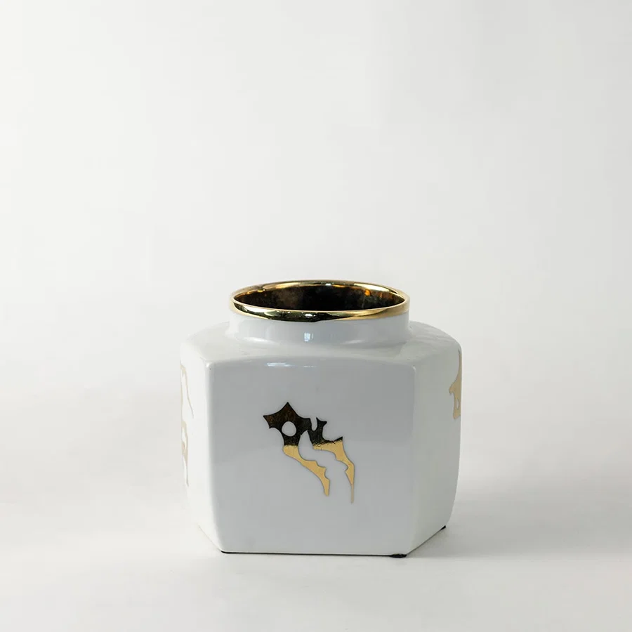 White ceramic decorative storage jar with gold bee artwork for contemporary tabletop styling and modern home decor.