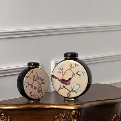 Pair of black round ceramic jars with pastel floral artwork in a front view perfect for elegant décor styling and artistic console display.