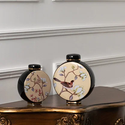Round ceramic jars with bird artwork arranged on a wooden console table creating a classic decorative décor accent that enhances interior styling beautifully.
