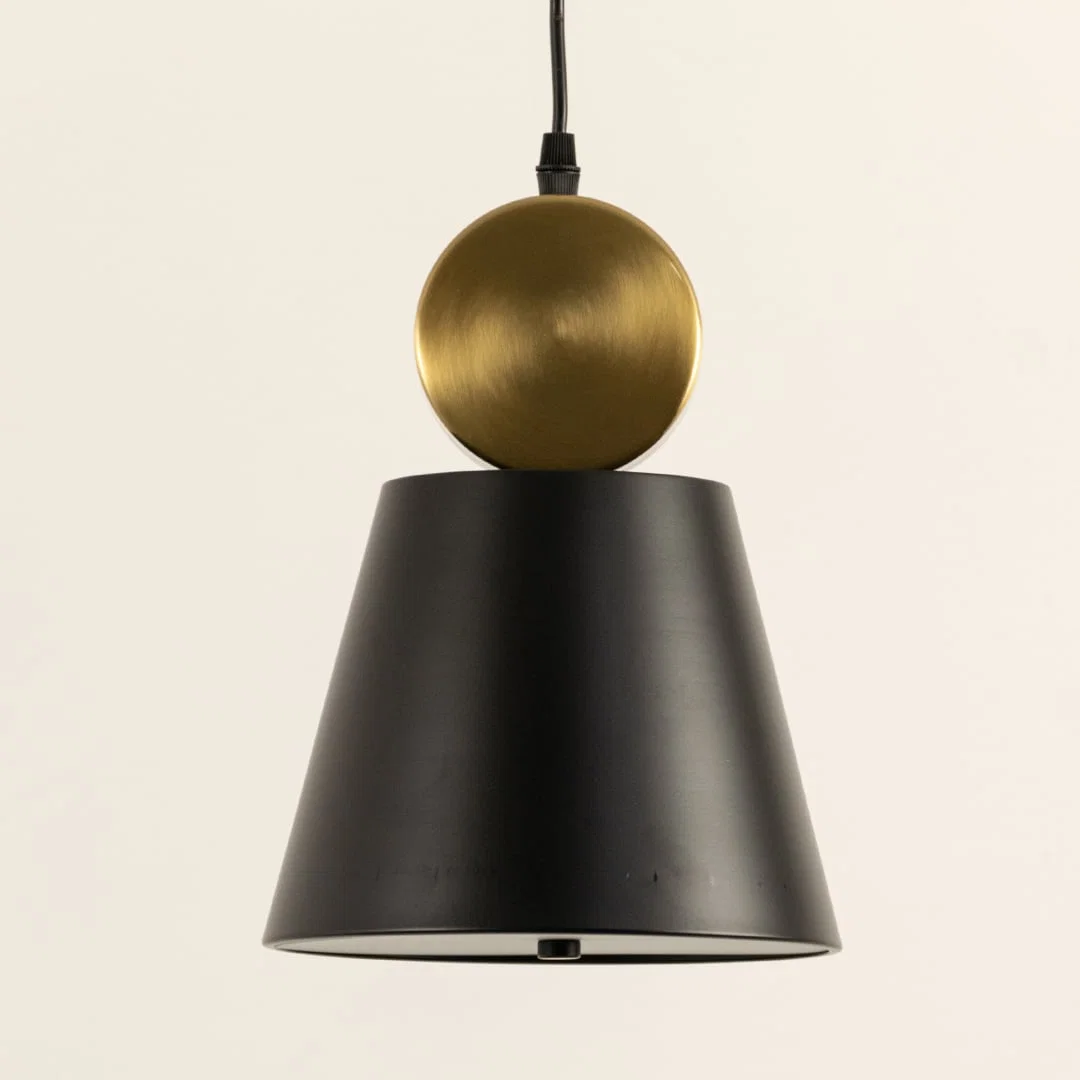 Black metal pendant light with gold accent illuminated to display contemporary ceiling lighting with luxury appeal.