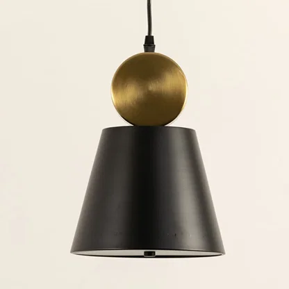 Black metal pendant light with gold accent illuminated to display contemporary ceiling lighting with luxury appeal.