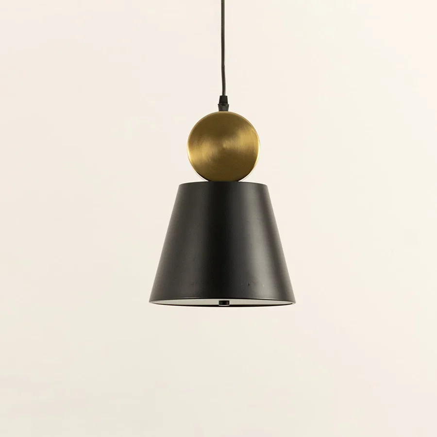 Black metal pendant light with gold sphere accent illuminated to display sleek modern decorative ceiling lighting.
