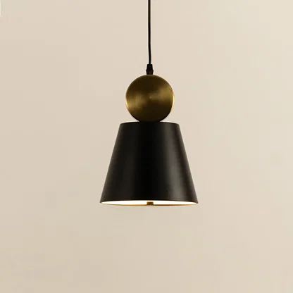 Closeup of black metal pendant light with gold top accent showing minimal cone design and smooth finish for modern interior decor.